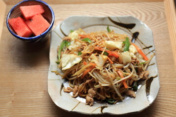 A large plate of sauce flavored fried noodles served further