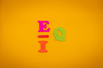IQ or EQ symbol. Intelligence quotient to EQ, emotional quotient on yellow background. Emotional and intelligence quotient concept