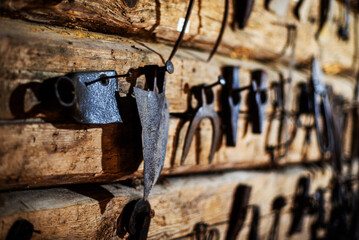 Workshop scene. Old tools hanging on wall in workshop. Vintage garage style