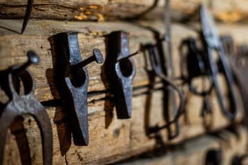 Workshop scene. Old tools hanging on wall in workshop. Old garage