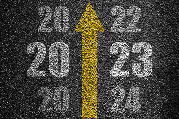 Direction to new year concept and sustainable development idea. Number of 2022 to 2024 on asphalt...