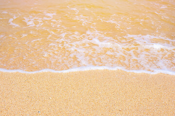 The coast of the Sea of Azov. Sea waves roll on the sandy shore. Seashell sandy beach.