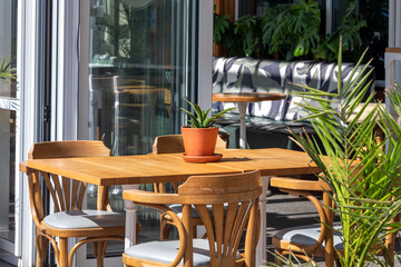 Empty table in outdoor cafe or restaurant. Tables and chairs at sidewalk cafe. Touristic setting, cafe table, sidewalk cafe furniture.