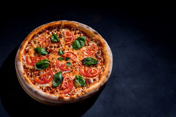 Delicious fragrant pizza with mozzarella, tomatoes and basil with tomato sauce - Margherita. Top view