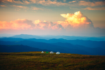 Attractive sunset in high mountains with camping on top. Carpathian mountains, Ukraine, Europe.