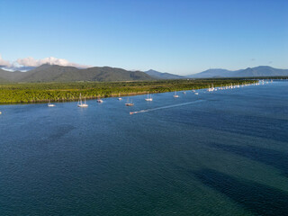 Aerial photo of perfect blue water and sky with mountains and boats