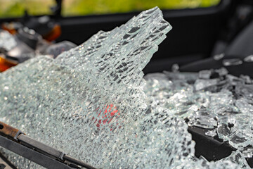 Close-up of the broken windshield on the car. Cracks in the glass after a car accident. close-up