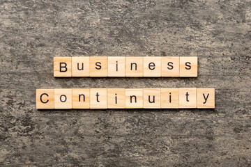 Business Continuity word written on wood block. Business Continuity text on cement table for your desing, concept