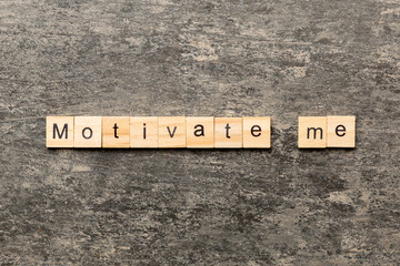 Motivate me word written on wood block. Motivate me text on cement table for your desing, concept