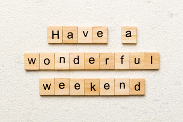 Have a wonderful weekend word written on wood block. Have a wonderful weekend text on cement table for your desing, Top view concept - obrazy, fototapety, plakaty