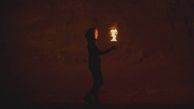 girl carries a bowl of fire in her hands