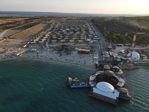 Aerial view of Zrce Beach Festival in Novalja, island Pag, archipelago of Croatia. People partying on a hot summer day on Zrce beach. Zrce beach is the most popular party destination on Adriatic sea.