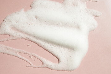 foam face wash texture, soap, shampoo on pink background