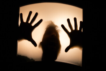 scary picture of hands behind glass, horror ghost woman behind door, Halloween  concept