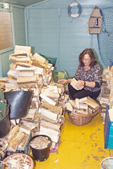 Woman with a stack of firewood.