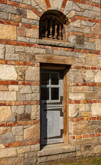 Fototapeta na wymiar Stone wall with wooden door