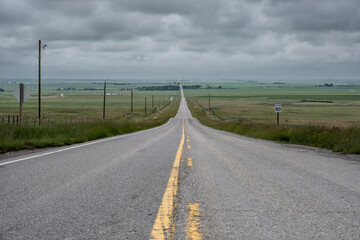 Fototapeta na wymiar Straight road in the vast plains of Alberta
