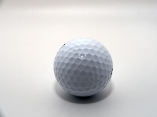 A golf ball shot in the studio on a white background