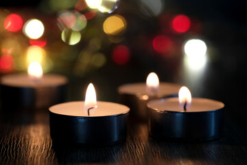 Candle light and bokeh background in the darkness with space for text or image.