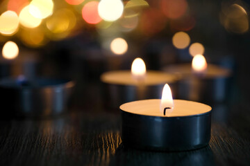 Candle light and bokeh background in the darkness with space for text or image.