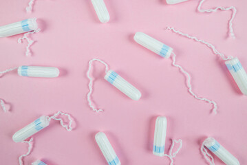 female tampons on a pink background. Hygienic white tampon for women. Cotton swab.