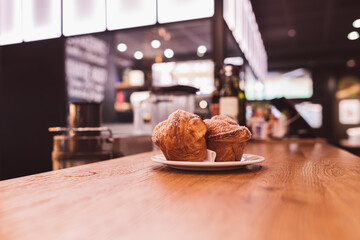 Two Muffins on a wood counter