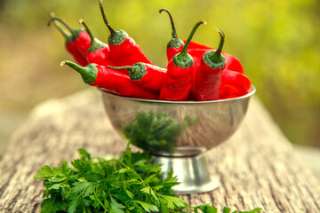 Red chili peppers on the table. Composition of red chili peppers and other spices. The concept of spices, seasonings, traditional cuisine.