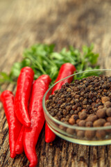 Red chili peppers on the table. Composition of red chili peppers and other spices. The concept of spices, seasonings, traditional cuisine.