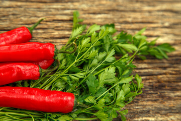 Red chili peppers on the table. Composition of red chili peppers and other spices. The concept of spices, seasonings, traditional cuisine.