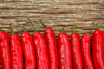 Red chili peppers on the table. Composition of red chili peppers and other spices. The concept of...