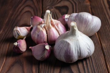 Garlic cloves on wooden table. Fresh peeled garlics and bulbs.