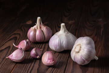 Garlic cloves on wooden table. Fresh peeled garlics and bulbs.