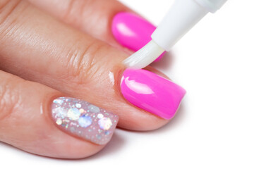 Cuticle gel. Master applies cuticle gel in the beauty salon. Professional care for hands.