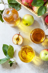 Autumn vitamin drink juice apple. Apple juice in a glass and fresh apples on a stone tabetop. View from above.