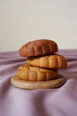 Traditional Chinese mid-autumn festival mooncake on beige cloth.