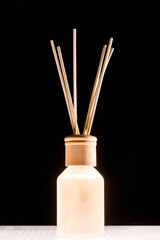 Fragrance for home. Aroma diffuser glass jar with aromatic liquid and bamboo sticks