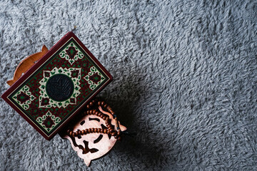 The Holy Al Quran with written Arabic calligraphy. Al Quran and rosary beads or tasbih