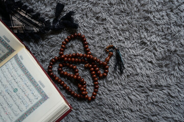 The Holy Al Quran with written Arabic calligraphy. Al Quran and rosary beads or tasbih