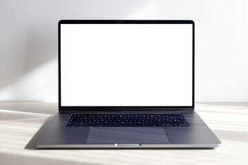 Modern laptop with blank white screen on minimalist desk