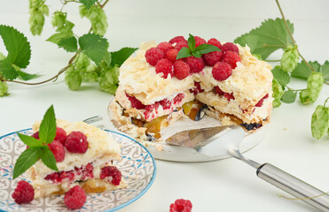Round meringue pie with fresh raspberries on a white background, Pavlova dessert