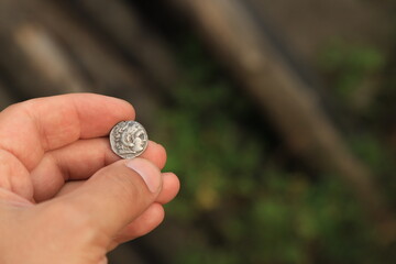 Antique Greek coin in hand