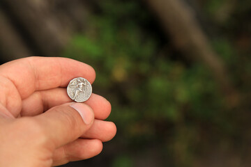 Antique Greek coin in hand