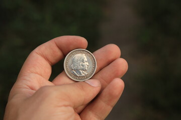 Old half dollar silver coin in hand