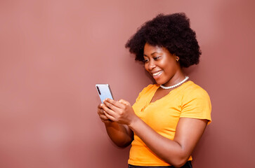 Fototapeta na wymiar Portrait African American businesswoman using phone isolated on brown background