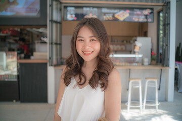Fototapeta na wymiar Pretty asian woman posting in coffee shop city travel