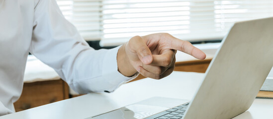 cropped view business people working and hand pointing on mobile laptop computer in meeting room office, online marketing, business finance meeting, investment, digital technology concept
