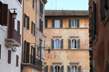 Fototapeta na wymiar Traditional Building Facades with Shutters, Balconies and Lantern in Rome, Pantheon Area, Italy