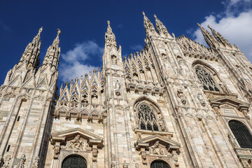Fototapeta premium Duomo di Milano in Lombardy. Beautiful Gothic Architecture in Milan with Blue Sky. Exterior of Italian Monument.