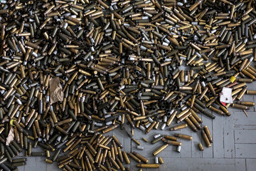 on the floor in the shooting range there are casings from fired cartridges of various calibers -...