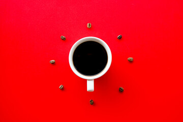 Black hot coffee cup on red background with Coffee beans arrange as forming clock face
